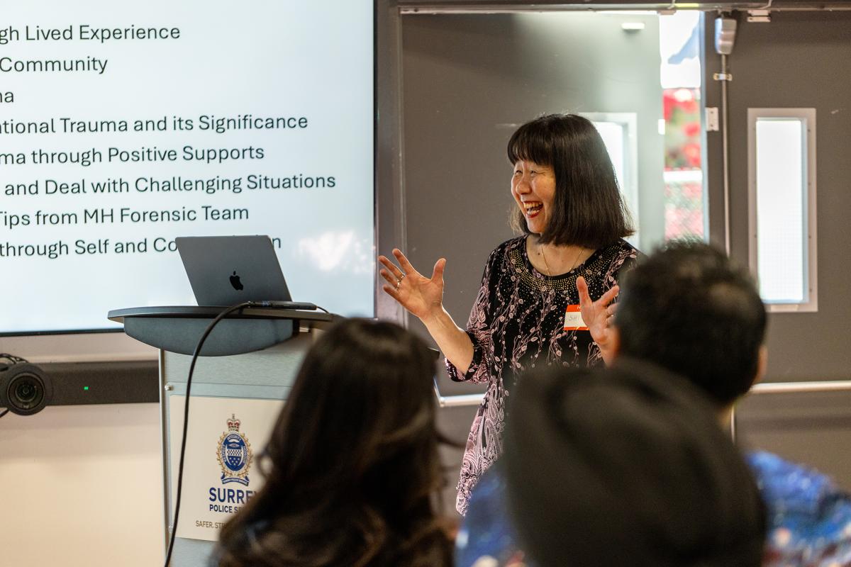 Dr Shirley Sze talks at a podium, smiling