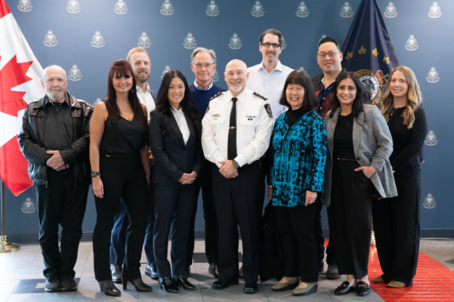 Police and physician presenters, along with Richard, pose for a group photo.