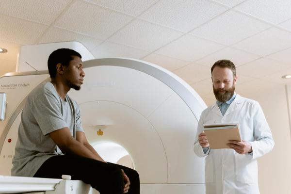 Doctor speaks to patient at MRI machine